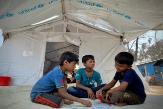 UNICEF ayuda a quien lo necesita con actividades recreativas para tres niños.  
